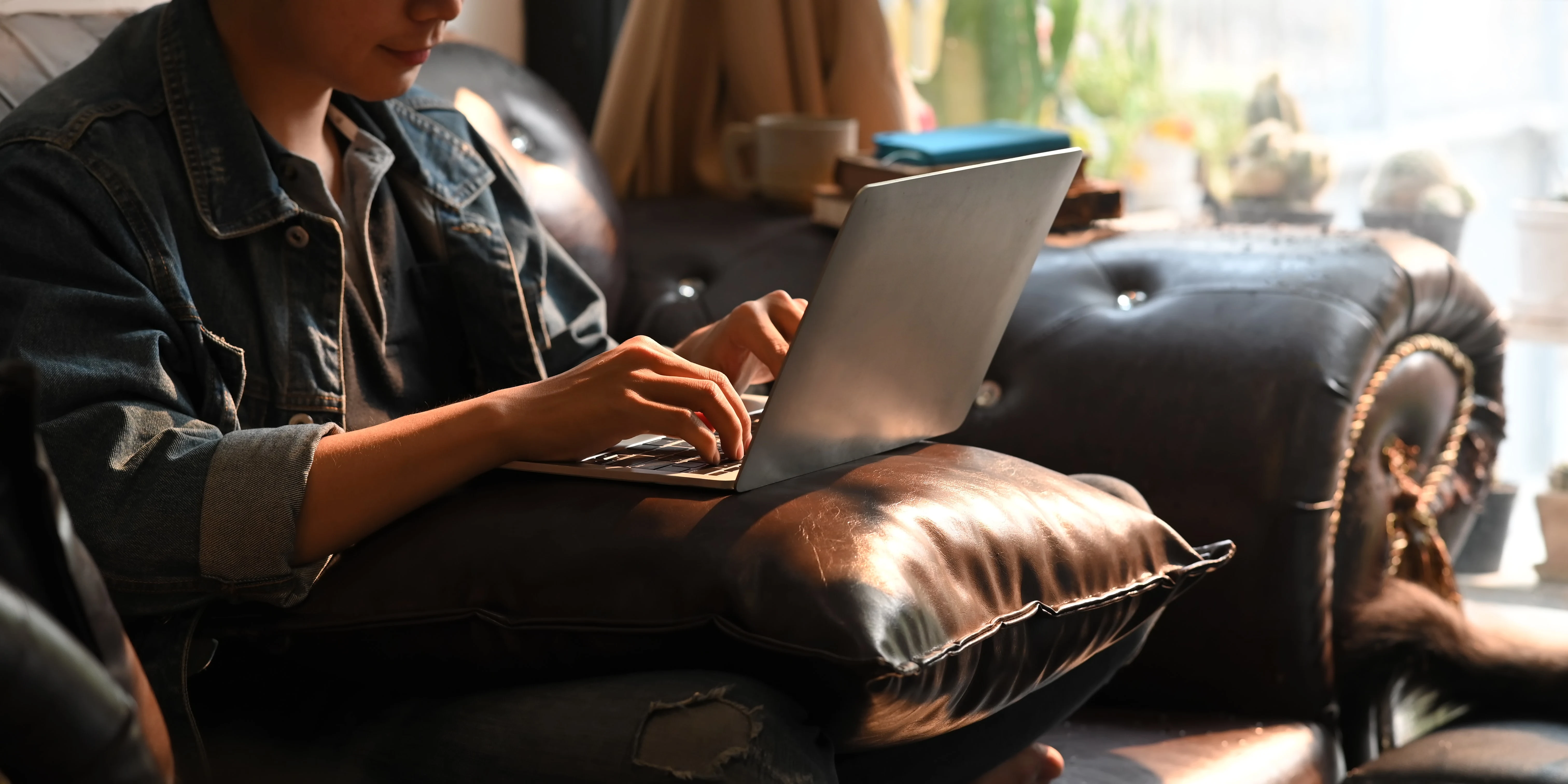 male student typing on a laptop