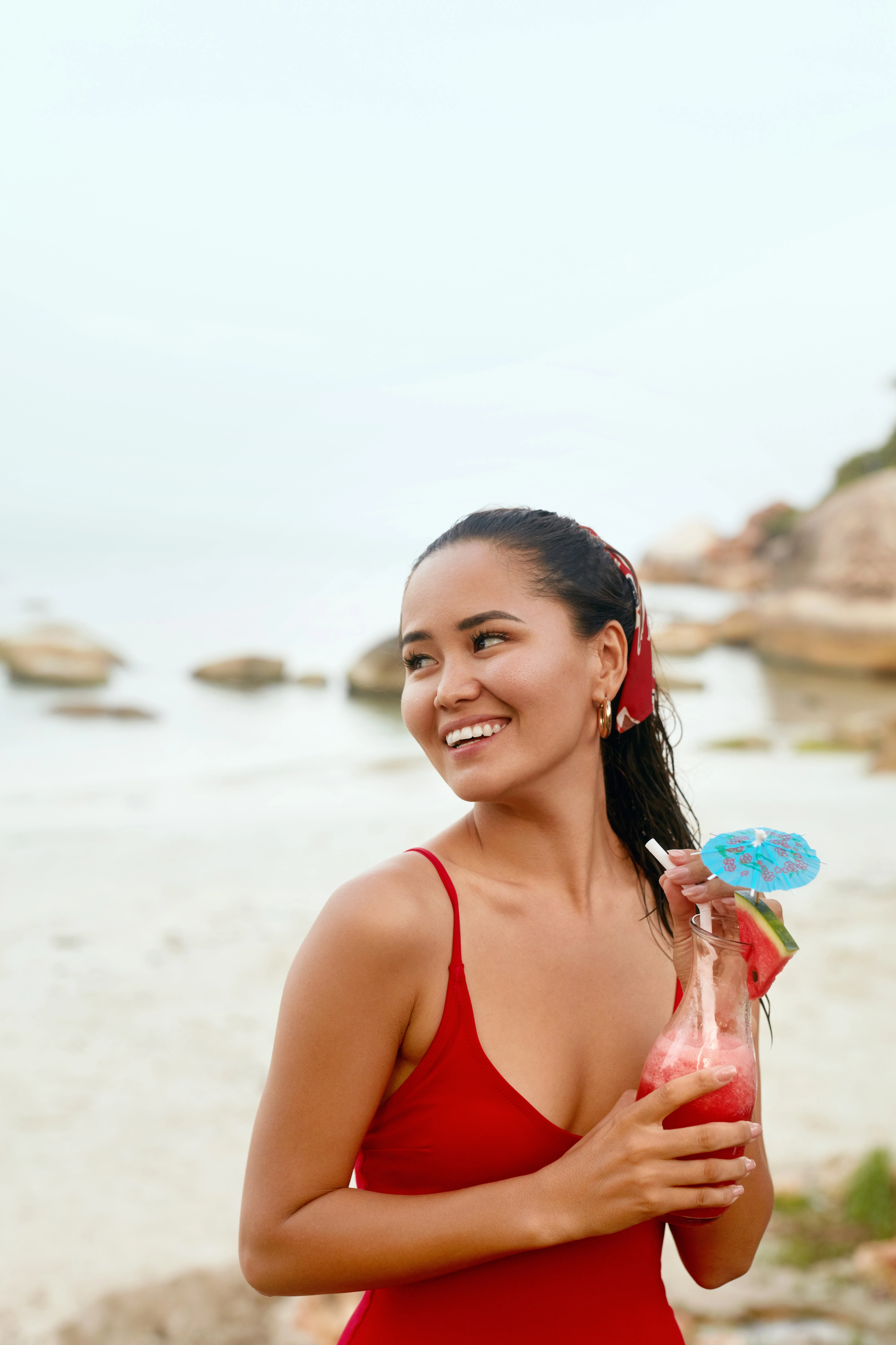 woman with a cocktail on a beach