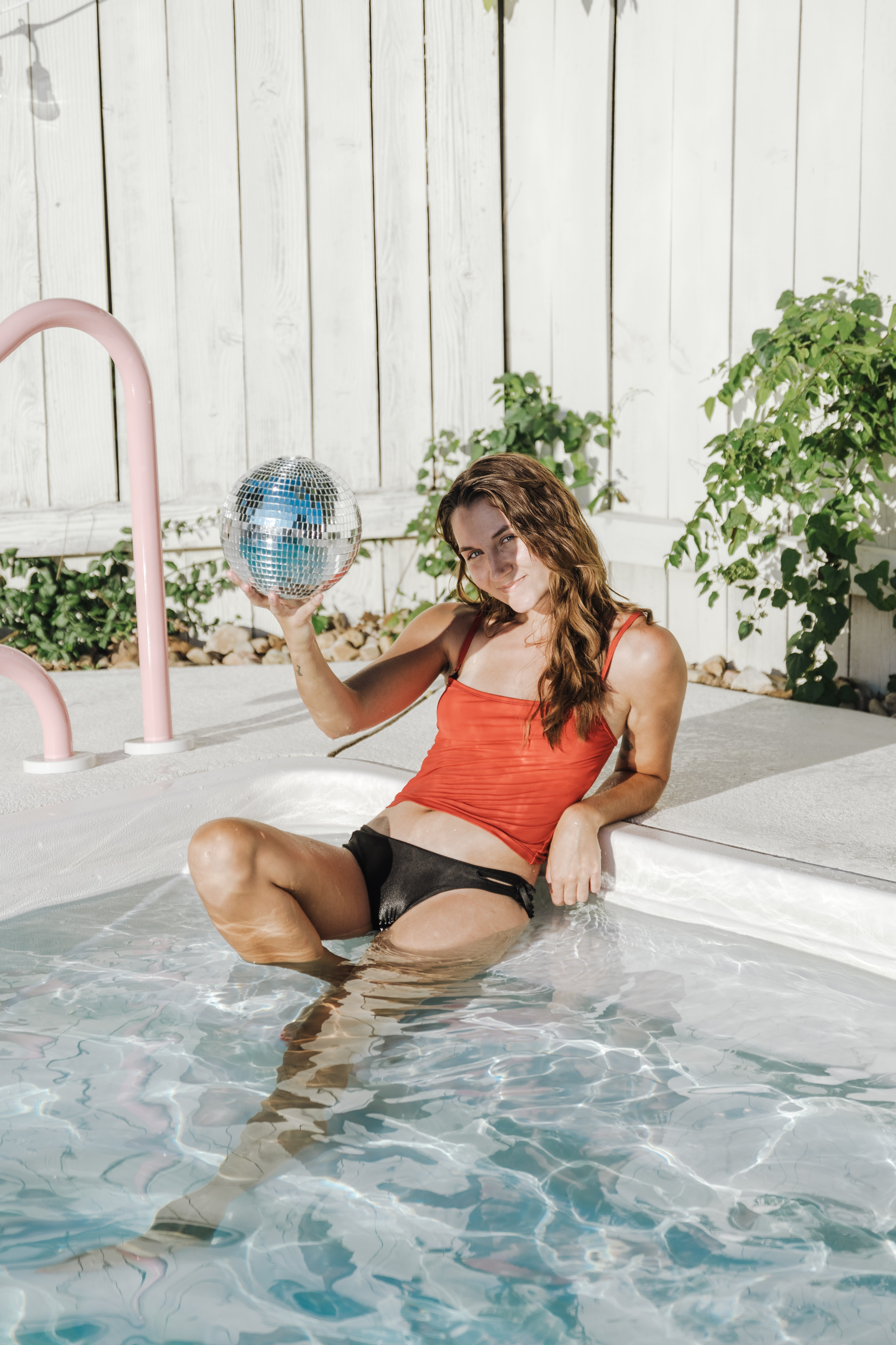 girl in a pool with a disco ball