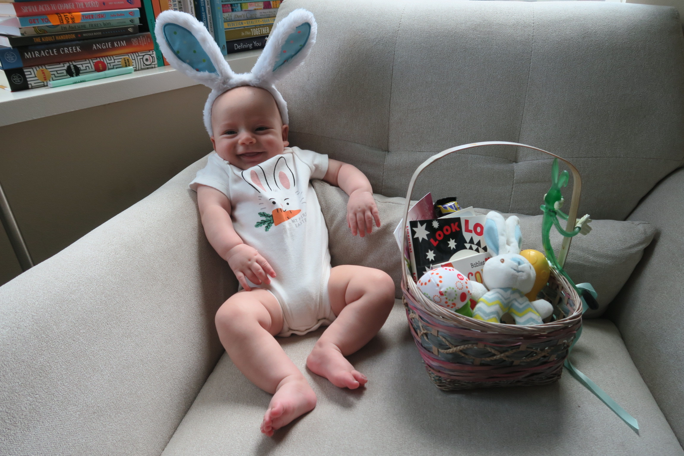 toddler easter basket ideas photo of a baby wearing bunny ears next to an easter basket - copyright nicole booz / genthirty.com / gentwenty, llc