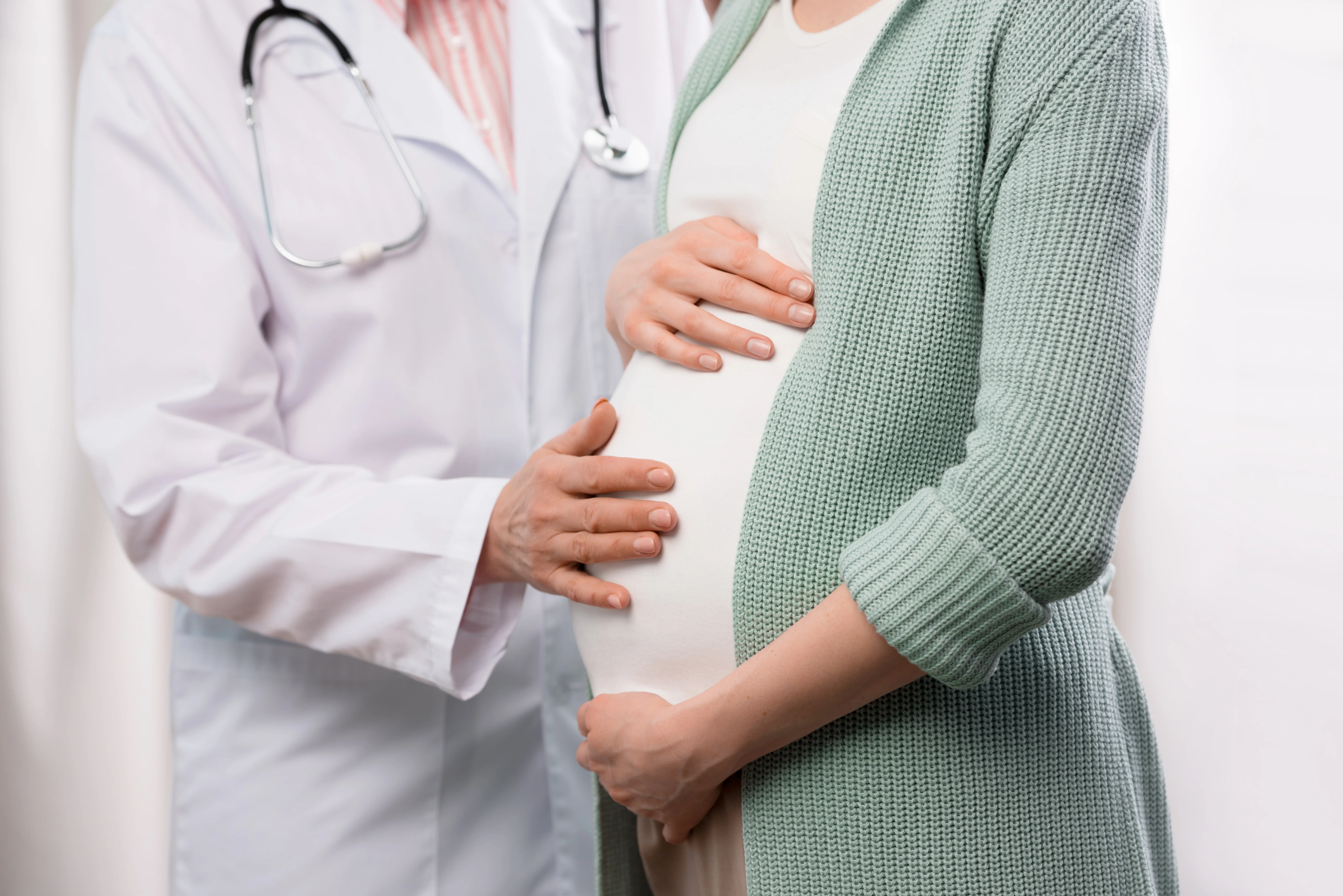 pregnant woman holding her belly