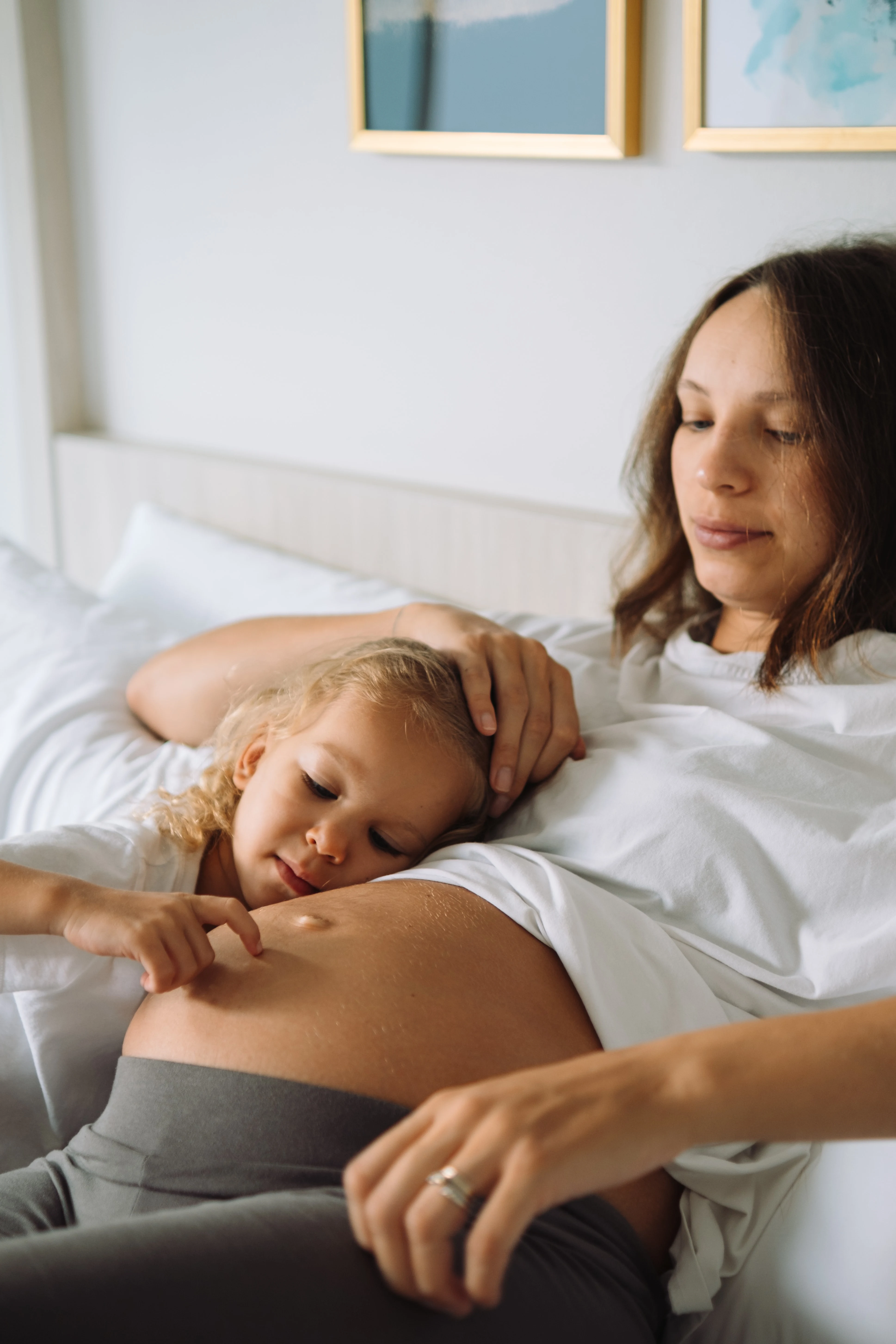 pregnant woman holding toddler