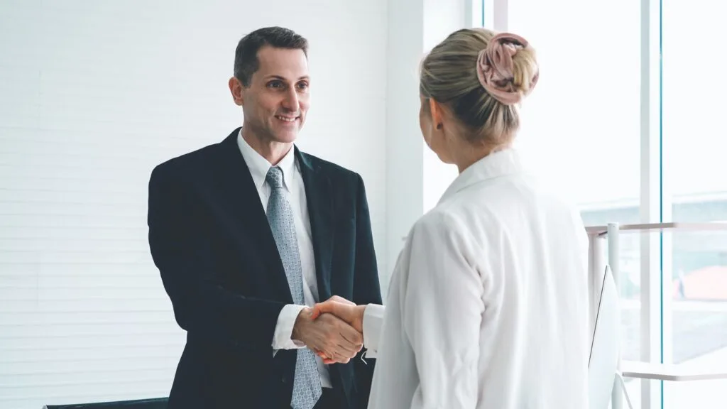 man and woman shaking hands