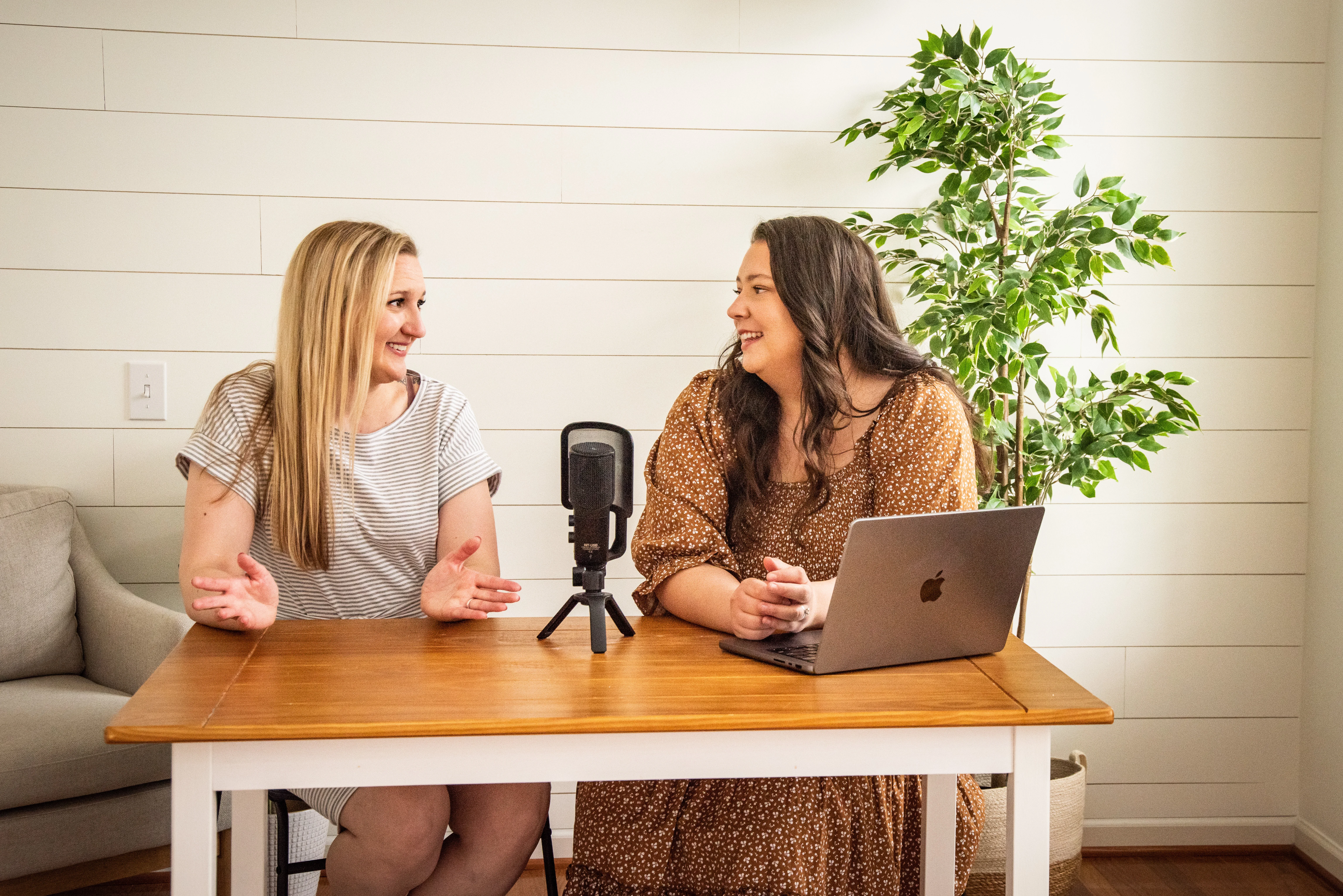 two woman talking about work at a desk