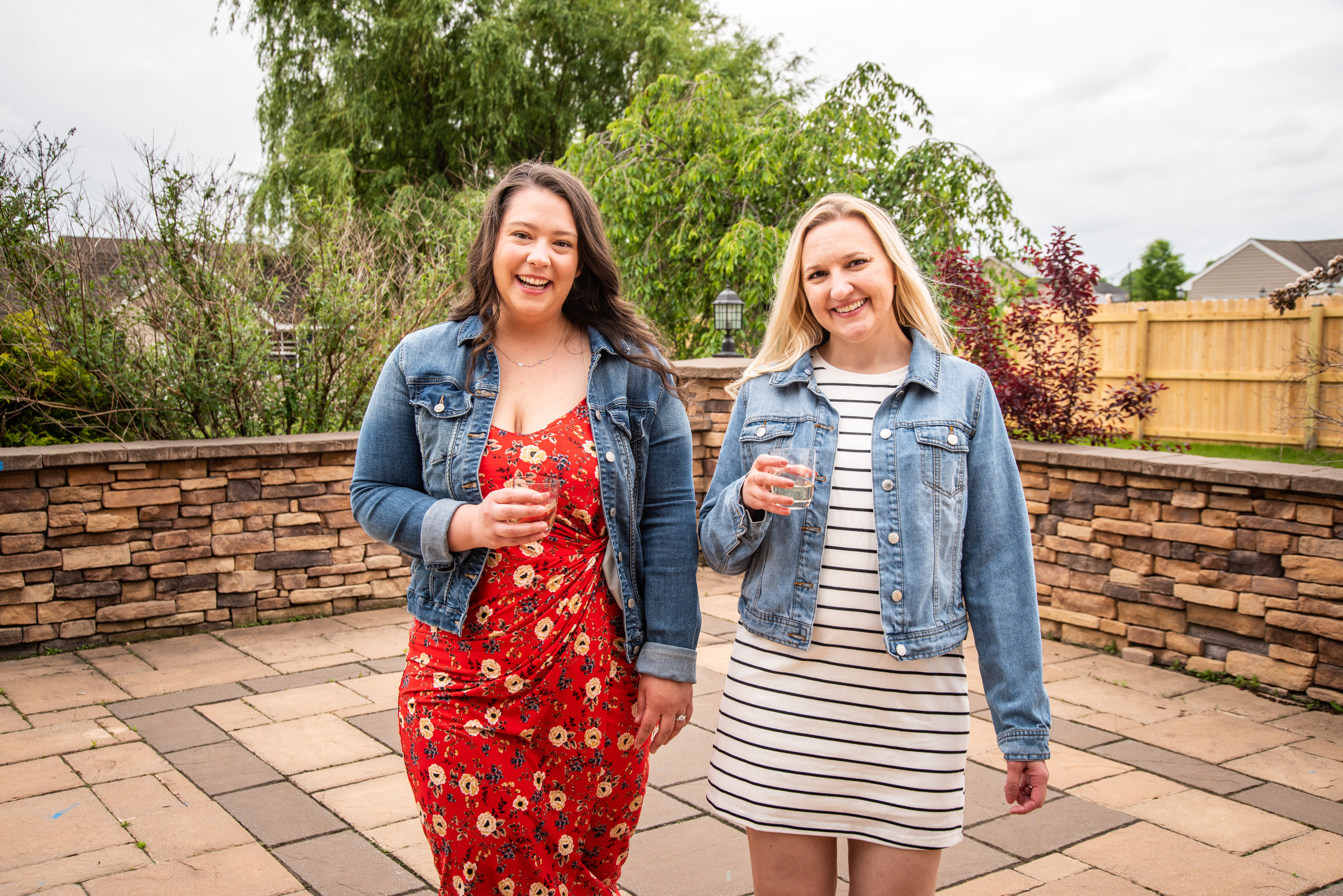 two women drinking wine outside