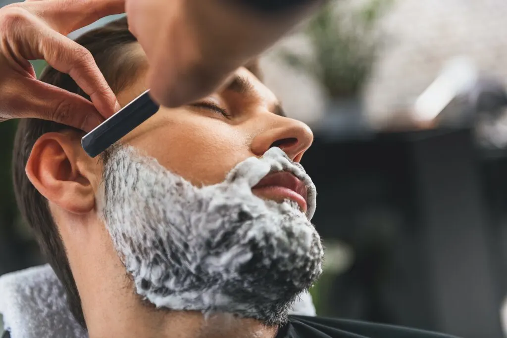 man shaving beard